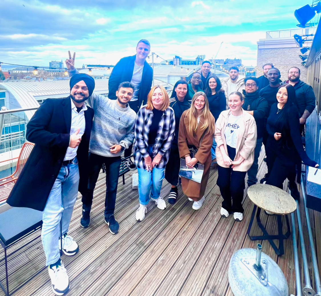 A group of people standing on a deck.