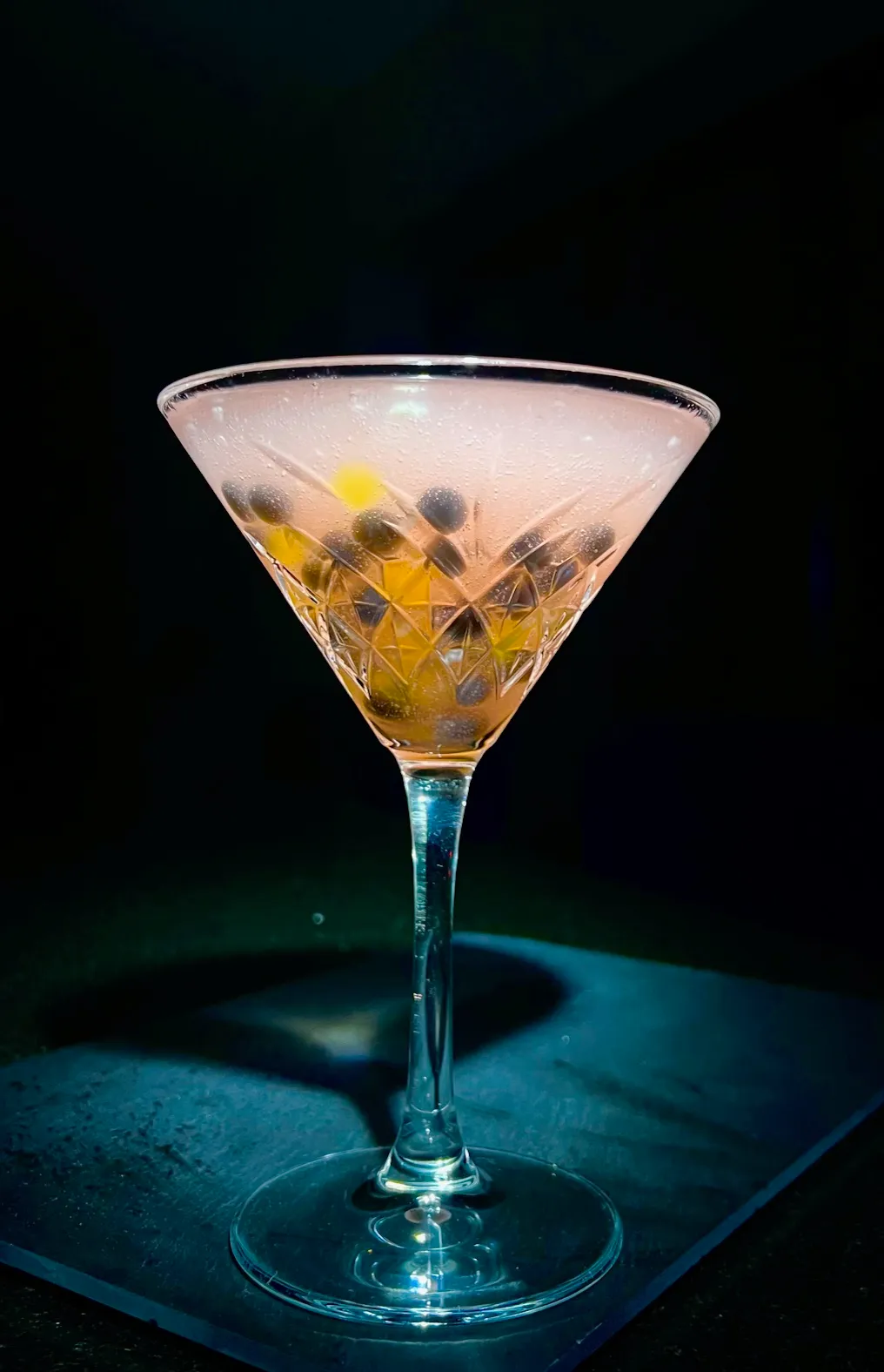 A glass filled with a drink sitting on top of a table